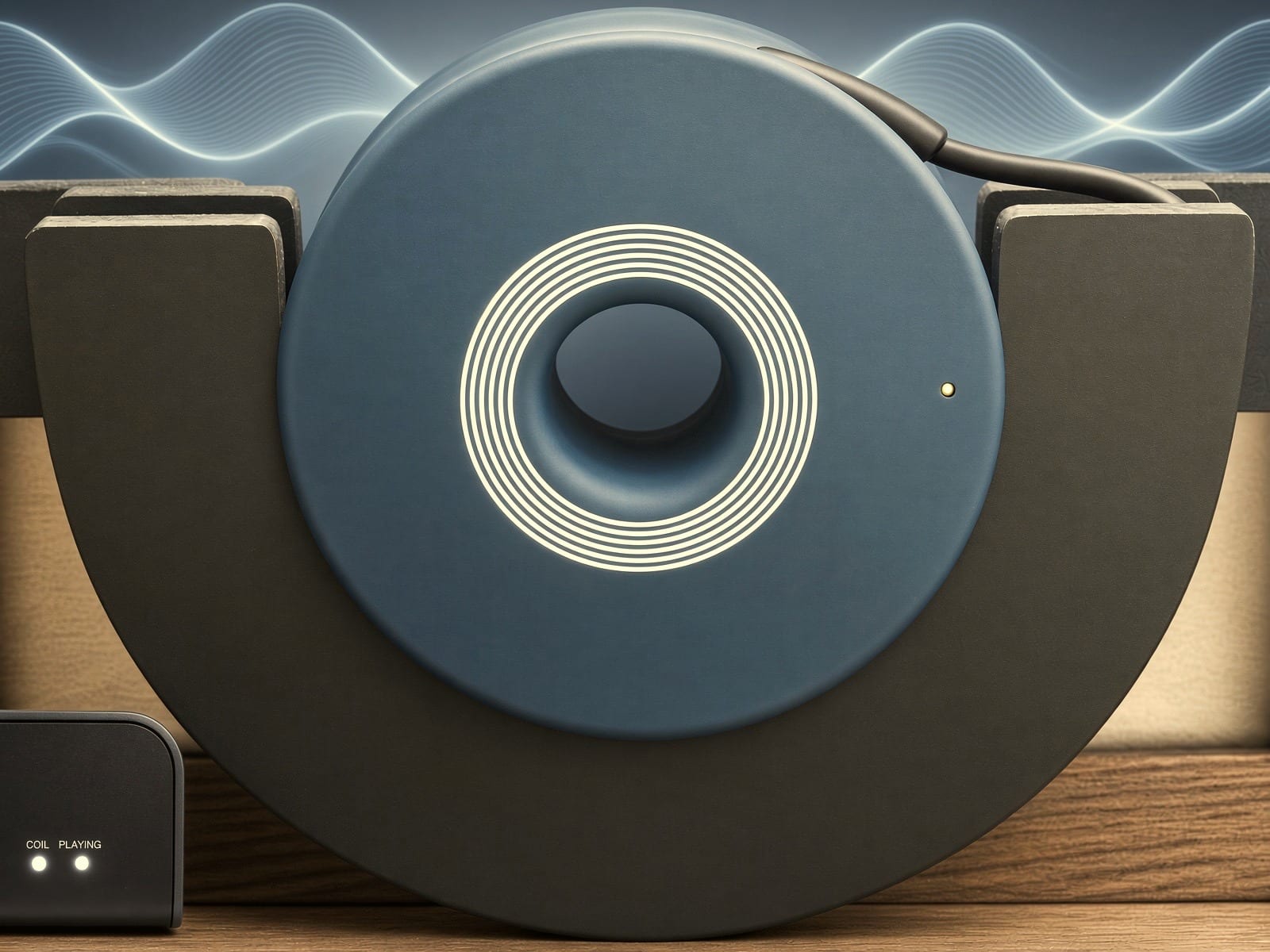 A symphonic PEMF coil resting in its cradle beside the control unit, with soft frequency waves in the background